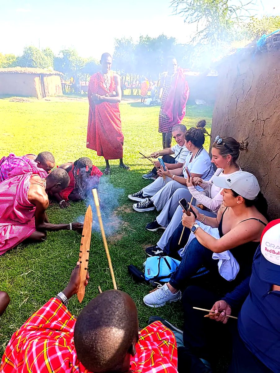 Guests taking part in a Maasai fire-making demonstration